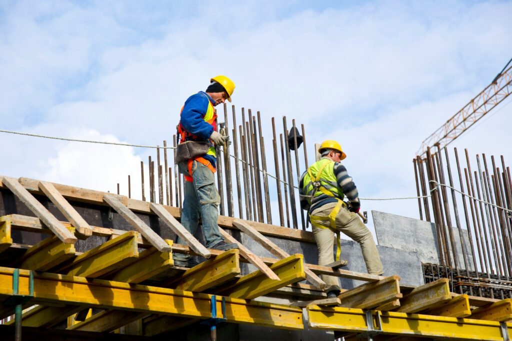 Construction Company executing a large-scale building project with coordinated teams and heavy equipment on site
