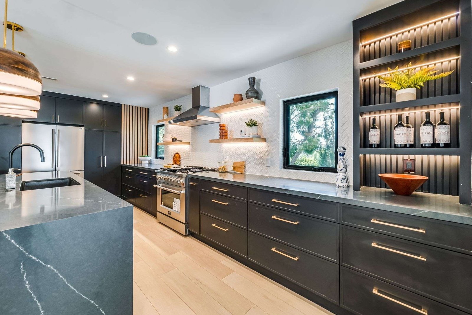 Spacious open-plan kitchen with island seating, pendant lights, and modern finishes.